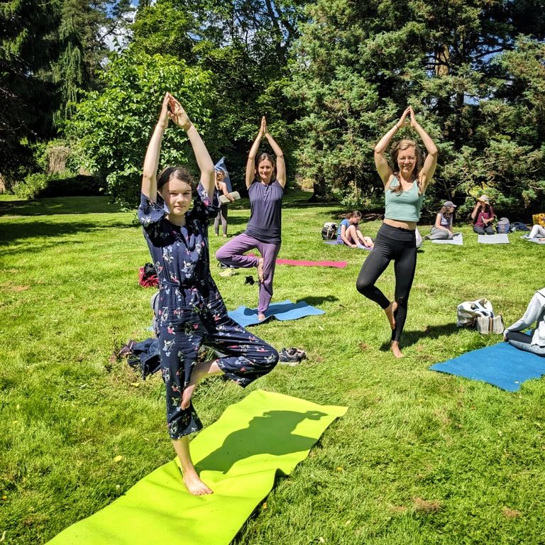 Three girls doing outdoor yoga